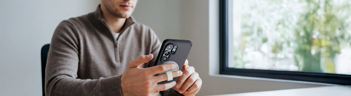 MagFit phone case with magnetic ring grip used by person holding smartphone near window indoors