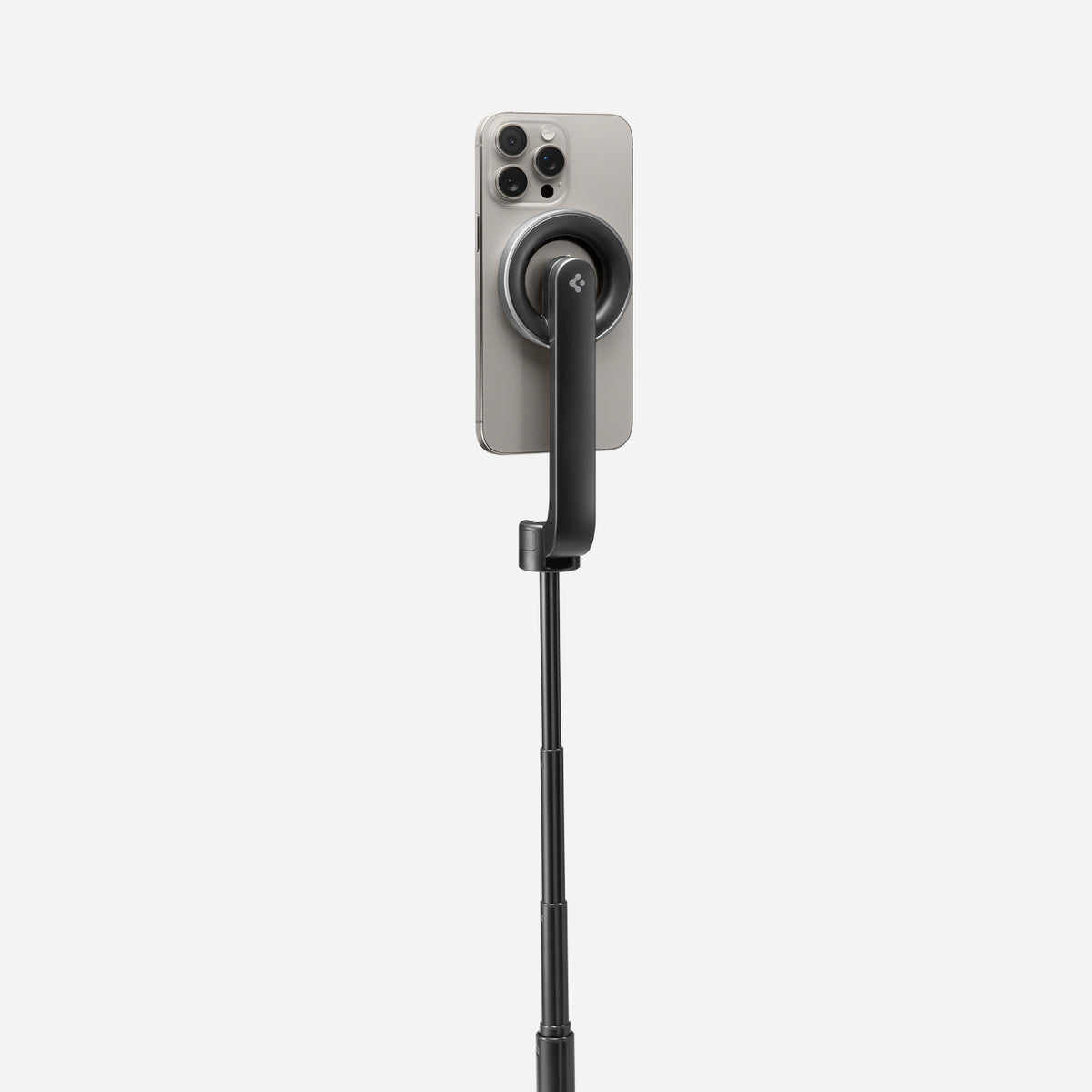 AMP07659 - Tripod Selfie Stick (Mag Fit) | S580W in Black showing the back of an iPhone attached magnetically to the S580W selfie stick via the MagFit mount, with the stick fully extended against a light gray background.