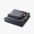 ACP11389 - Two folded gray Spigen microfiber car drying towels stacked together with orange brand tags