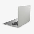 ACS10975 - MacBook Air 15-inch in Heather Gray showing the top and side with laptop slightly open and charging cable next to port
