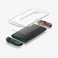 AGL10156 - Nintendo Switch 2 GLAS.tR EZ Fit in Clear showing the installation tray hovering above the screen protector and the device