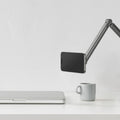 AMP09694 - Phone OneTap Clamp (MagFit) in Space Gray showing the  front of the device and partial arm of the holder