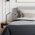 AMP09694 - Phone OneTap Clamp (MagFit) in Space Gray showing the attached beside the bed