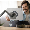 AMP09191 - OneTap Clamp in Space Gray showing a person holding the device, ready to attach it to the clamp stand.