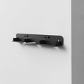 AHP06847 - Carabiner (Magnetic Keychain) Holder Hub in Black showing a screw hovering above the keychain holder hub mounted on a wall