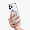 AMP10193 - O-Mag Magnetic Phone Holder (MagFit) | OM103 in Sliver showing a person holding the ring holder attached to the device
