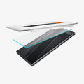 AGL07493 - Galaxy S24 Ultra GLAS.tR EZ Fit in Transparency showing the alignment tray hovering above the glass screen protector and a device on a flat surface