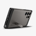 ACS07301 - Galaxy S24 Ultra Case Tough Armor in Gunmetal showing the back, partial side and bottom with a built-in kickstand propped up