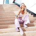 ACS09425 - Galaxy S25 Edge Case Liquid Crystal in Crystal Clear showing a woman holding the device with the case while sitting on a stair