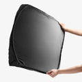 ACP11459 - Universal CryoShade UO260 S showing hands holding fully expanded black sunshade with reflective silver interior facing outward
