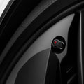 ACP11371 - Universal Tire Valve Stem Cap | VS100TS/R in Red showing the black hexagonal cap with red Tesla logo installed on a vehicle wheel valve stem.