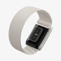 AMP10188 - WHOOP 5.0 fabric band starlight angled rear view showing integrated sensor module adjustable woven fabric strap and metal clasp