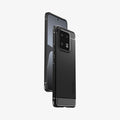 ACS05325 - Xiaomi 13 Pro Rugged Armor Case in Matte Black showing the back, partial side, hovering behind a device showing partial front and side