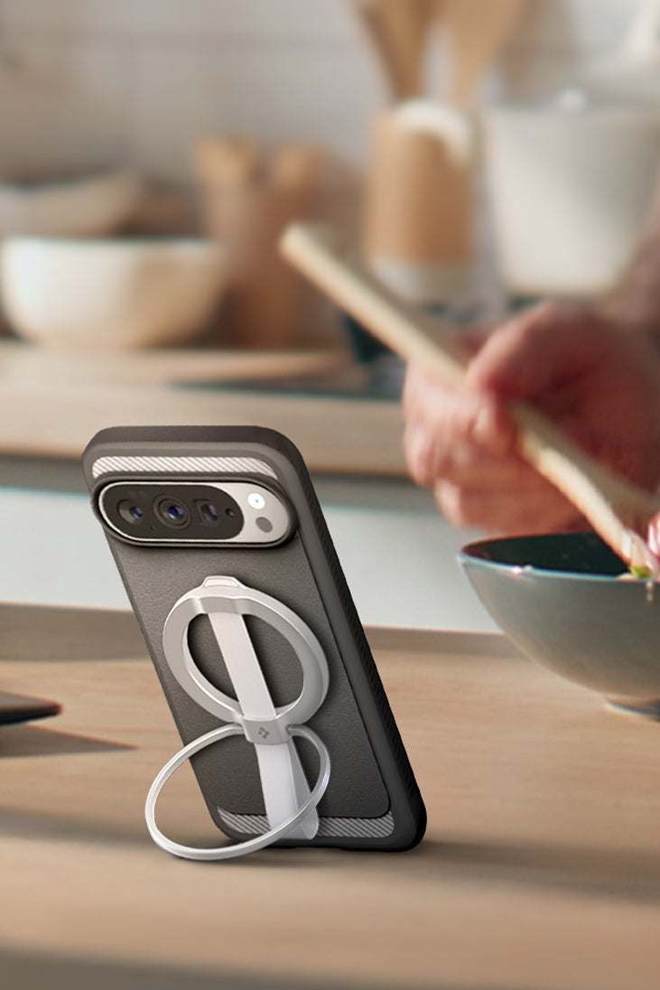 Person mixing salad with phone propped up with MagFit Accessory