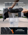 ACP11389 - Hands wringing water out of a Spigen microfiber towel over a 1-gallon bucket, demonstrating its 1200 GSM absorbency