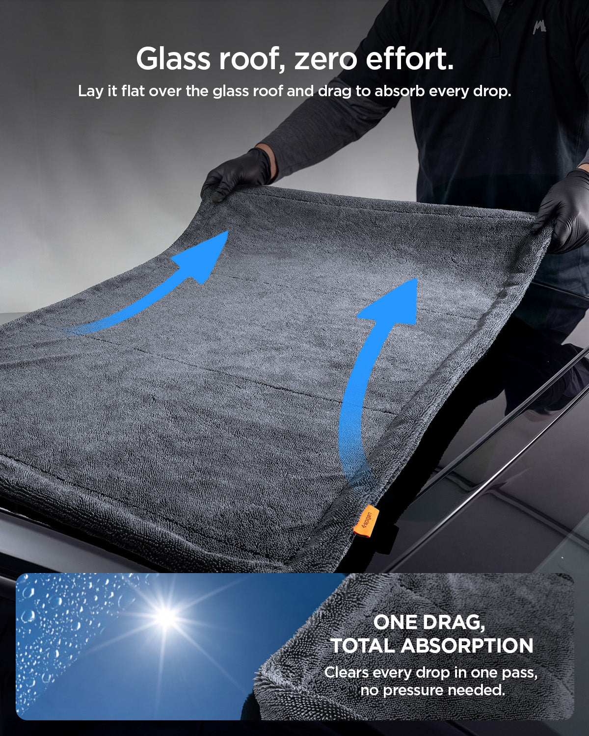 ACP11389 - Man dragging a Spigen microfiber towel flat across a car's glass roof to absorb water in one pass