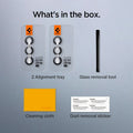 AGL07442 - Galaxy S24 Optik Pro EZ Fit Lens Protector in Gray showing what's in the box. 2 Alignment trays, Glass removal tool, Cleaning cloth and Dust removal sticker