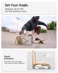 ACS11923 - iPhone 18 Pro / iPhone 17 Pro Ultra Hybrid Optik S (Mag Fit) Clear Orange showing the case propped horizontally with the camera ring stand for hands-free viewing