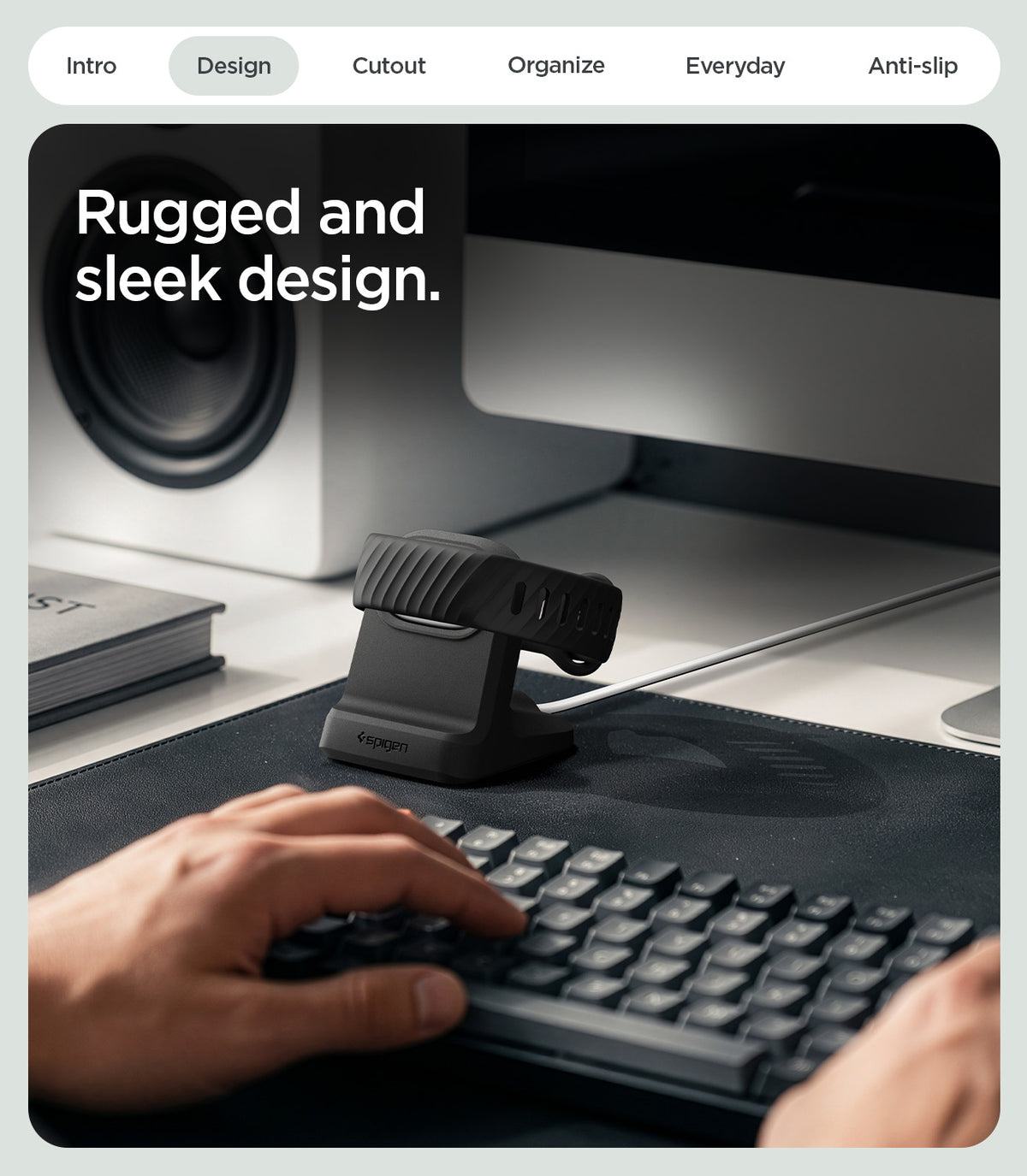 AMP11999 - Fitbit Air Night Stand | S356 in Black showing the charging stand holding a fitness band on a desk beside a keyboard