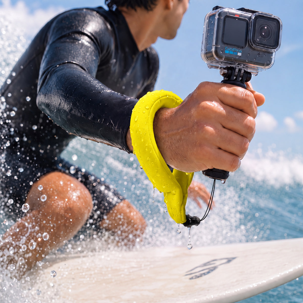 AMP11843 - Aqua Shield Floating Strap in Neon Yellow showing a person wearing a floating wrist strap while holding an action camera in the water