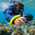 AMP11843 - Aqua Shield Floating Strap in Neon Yellow showing a person underwater wearing a floating wrist strap while holding an action camera