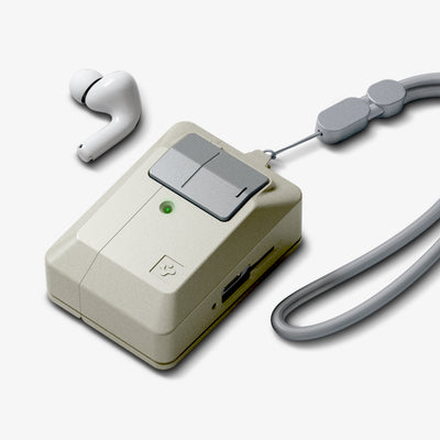 ACS10978 - AirPods Pro 3 Classic LS showing a rugged beige protective case with a secure latch, green LED indicator, attached lanyard, and a single AirPod placed beside the case.
