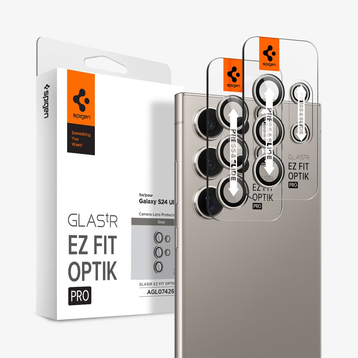 AGL07426 - Galaxy S24 Ultra Optik Pro EZ Fit Lens Protector in Gray showing the camera lens protector hovering above another lens protector tray and device showing back, behind it, is the packaging